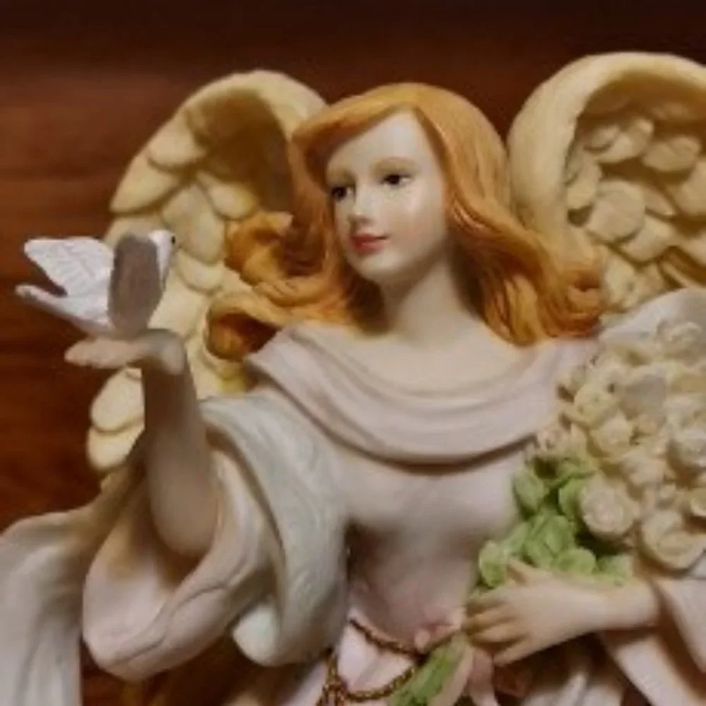 BEAUITFUL ANGLE HOLDING FLOWERS AND A BIRD IN HER HAND